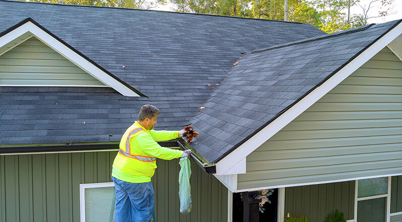 A Man Cleaning Roof Gutters-1