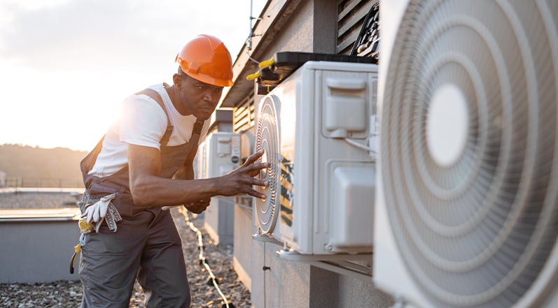 A Man Inspecting an HVAC System