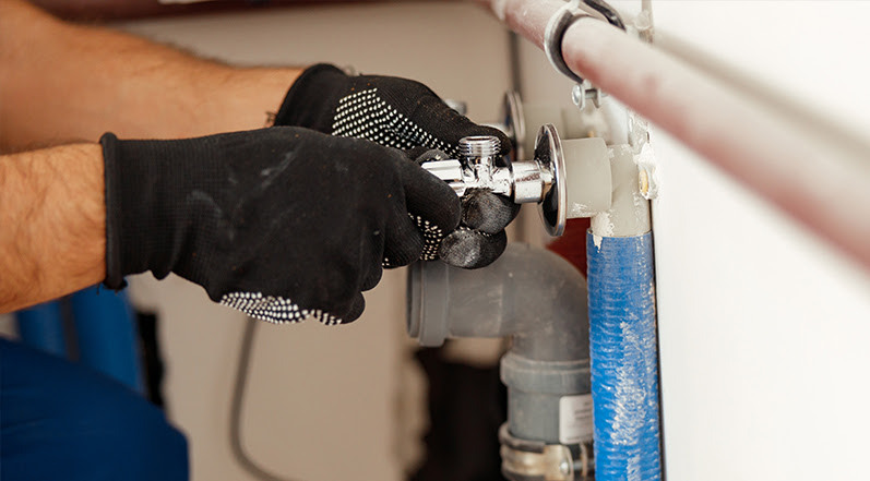 A Person Fixing a Leak