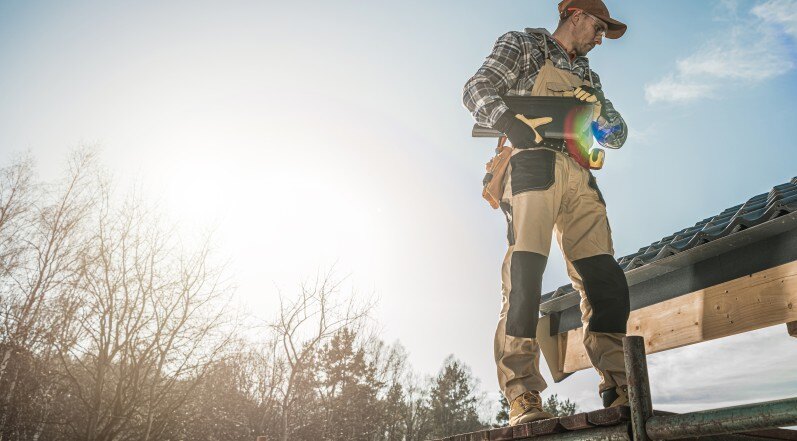 A Roofing Contractor Carrying Tools