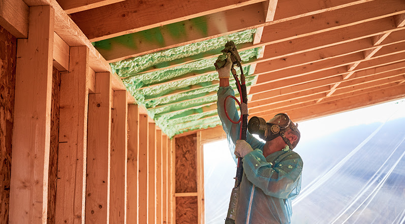 A Roofing Contractor Installing Insulation