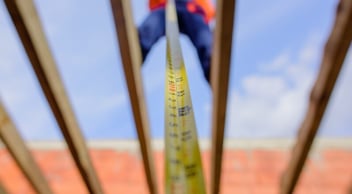 A Roofing Contractor Making a Measurement