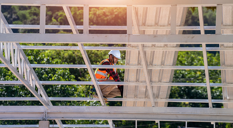 A Roofing Contractor Working on a Warehouse Roof