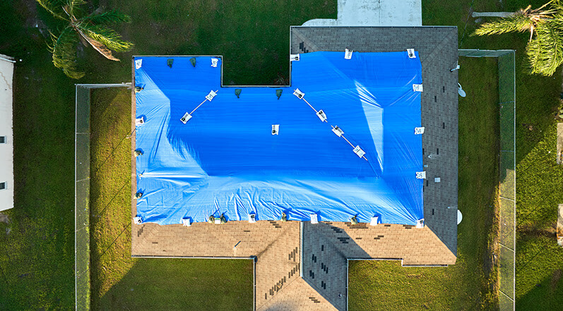 A Tarp Covering Roof Damage