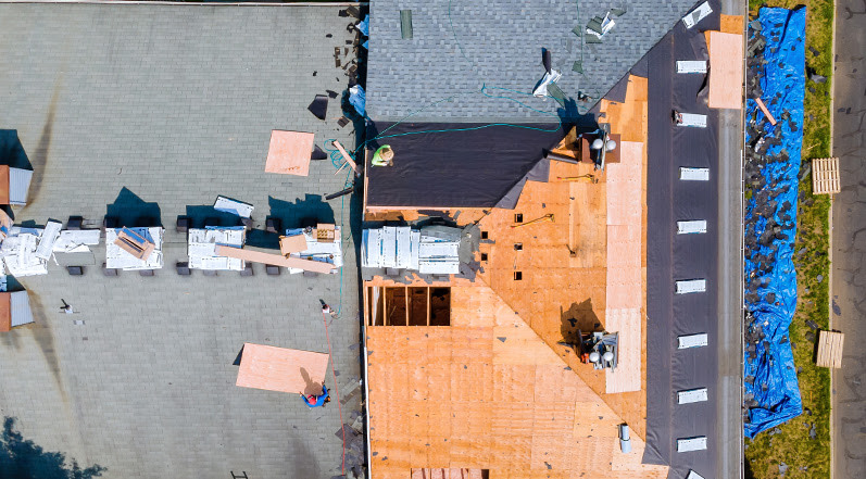 A Team Restoring a Damaged Roof