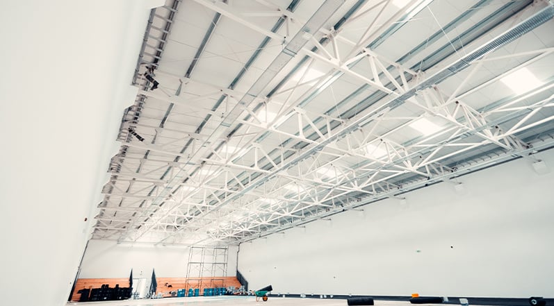 An Empty Warehouse With a Metal Roof