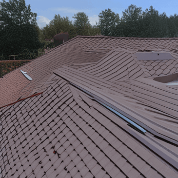 Picture of brown synthetic roof shingles on a gable of a roof next to the ridge