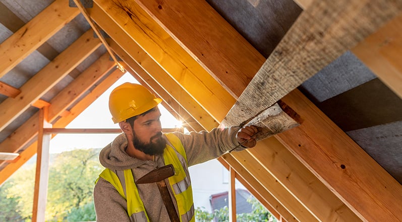 Contractor Installing Roof Underlayment