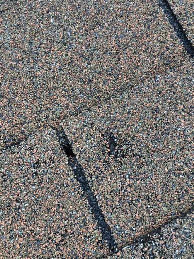 Hail damaged shingle on a roof.