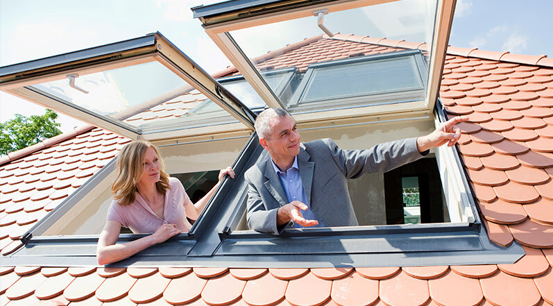 People Looking Out of Roof Skylights