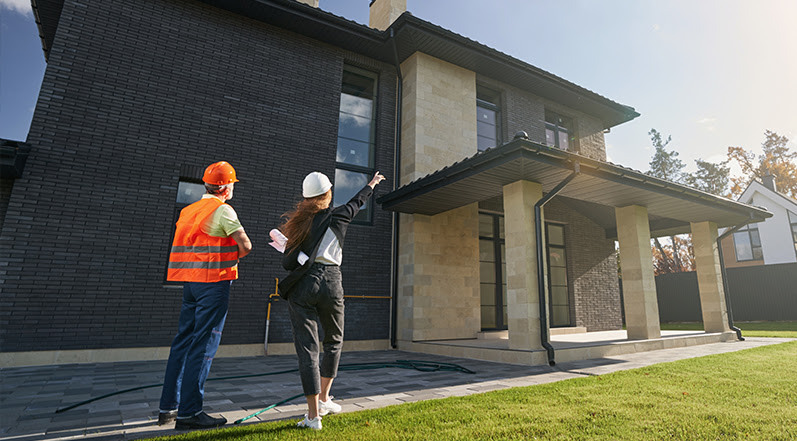 Roofing Contractors Looking at a Home