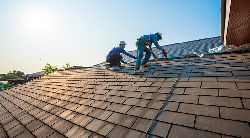 Roofing Contractors Repairing Damage