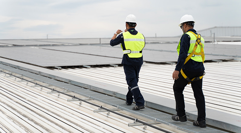 Roofing Contractors on a Warehouse Roof