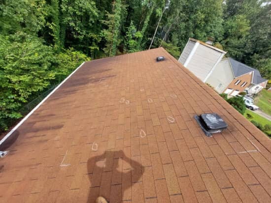 3-tab asphalt shingle roof in a brown color to show how long a shingle roof should last