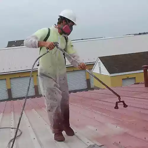 contractor-applies-metal-roof-coating-1.jpg